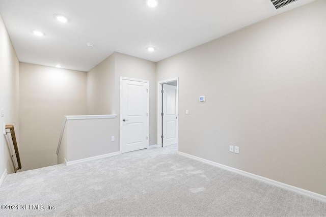 unfurnished room with light colored carpet