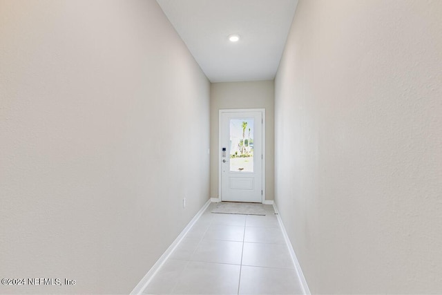 doorway with light tile patterned flooring