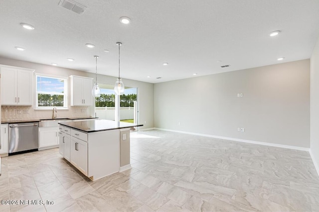 kitchen featuring dishwasher, decorative light fixtures, a kitchen island, and white cabinetry