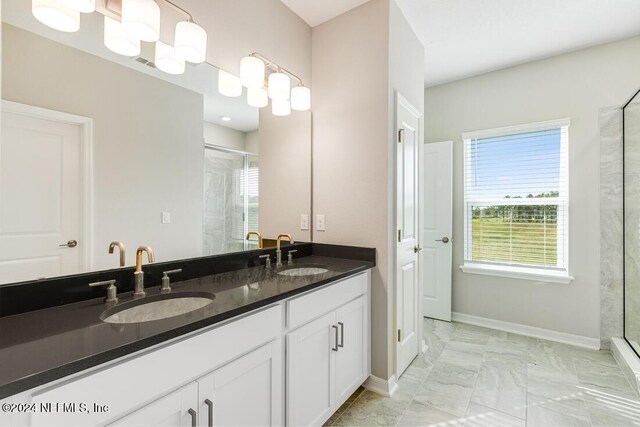 bathroom featuring vanity and a shower with shower door