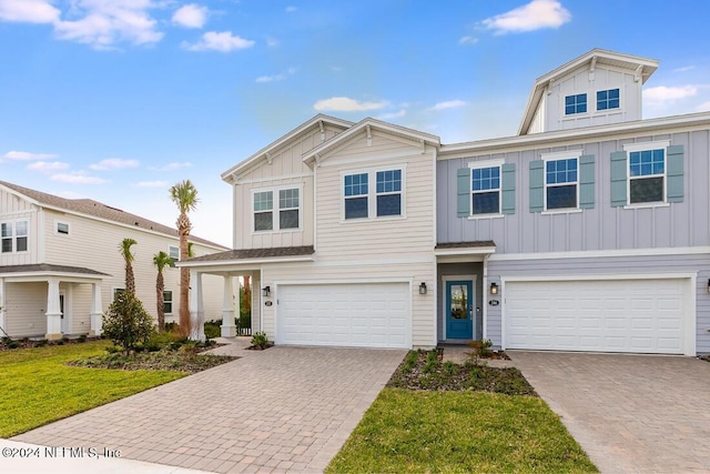 view of front of house featuring a garage and a front lawn