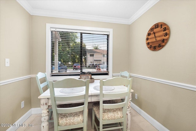 dining room with crown molding and light tile patterned floors