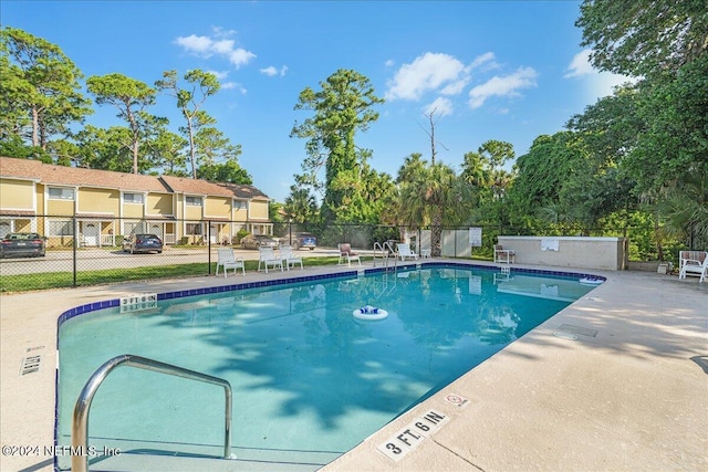 view of swimming pool with a patio