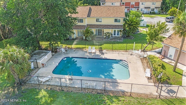 view of swimming pool featuring a lawn and a patio