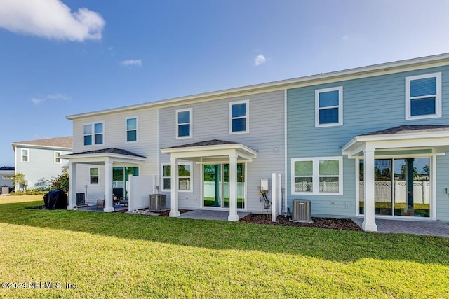 back of property featuring a lawn, a patio, and central AC