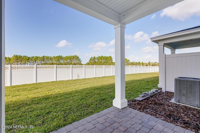 view of yard featuring central AC and a patio area