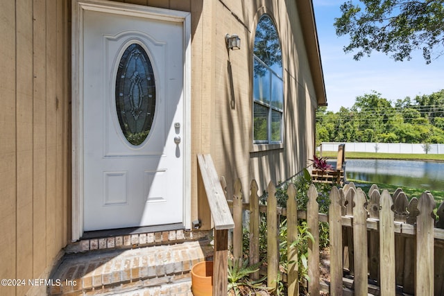 doorway to property with a water view