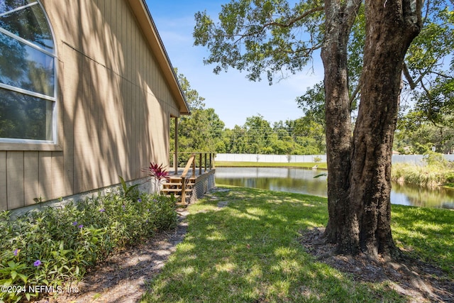 view of yard with fence and a water view