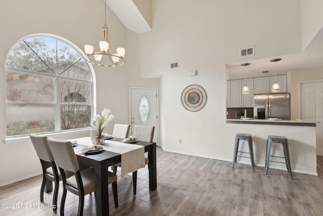 dining room with visible vents, baseboards, and wood finished floors