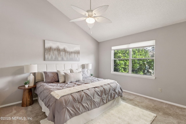 bedroom featuring a textured ceiling, baseboards, lofted ceiling, and carpet floors