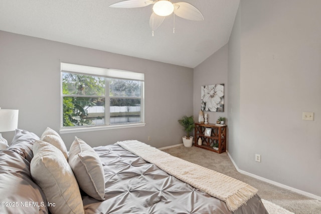 bedroom with light colored carpet, ceiling fan, baseboards, and vaulted ceiling