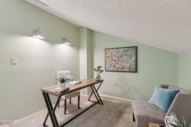 office area with visible vents, light carpet, a textured ceiling, and vaulted ceiling