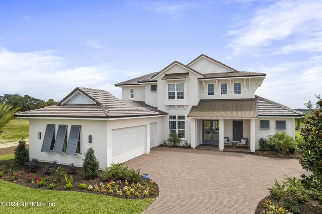 view of front of home with a garage and covered porch