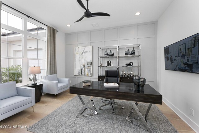 office space with light wood-type flooring and ceiling fan