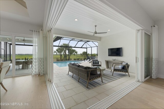 living room with ceiling fan and light wood-type flooring