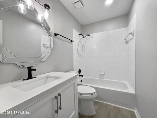 full bathroom with vanity, toilet, and tiled shower / bath