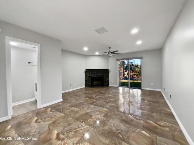 unfurnished living room featuring a fireplace and ceiling fan