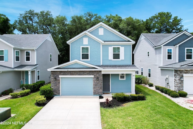 view of front of property featuring a garage and a front yard