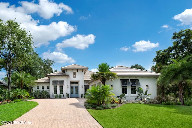 mediterranean / spanish house featuring a front yard