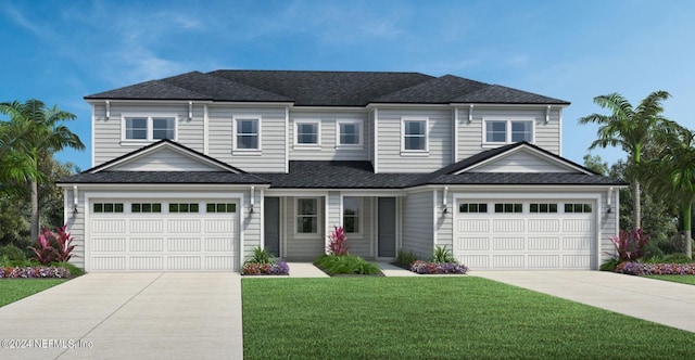 view of front of property featuring a front yard and a garage