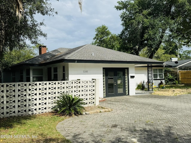 ranch-style house featuring french doors