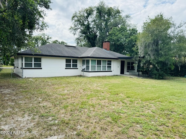 rear view of house with a lawn