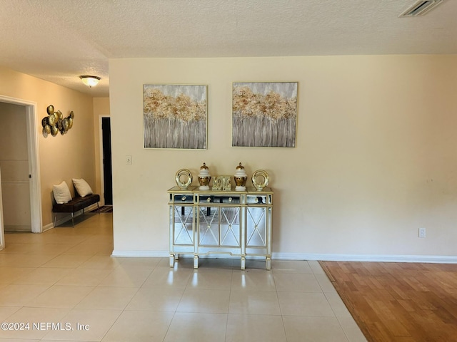 interior space featuring a textured ceiling and light hardwood / wood-style flooring