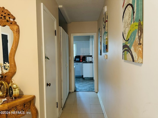 hall with light tile patterned flooring