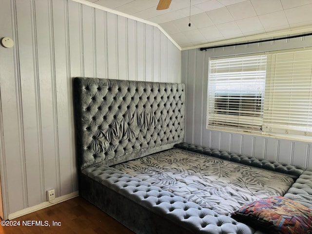 bedroom with ceiling fan, dark hardwood / wood-style flooring, ornamental molding, and vaulted ceiling