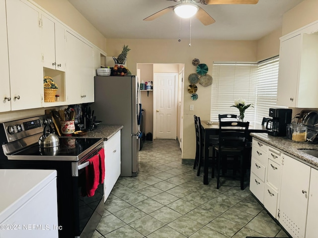 kitchen with white cabinets, light tile patterned floors, stainless steel appliances, and ceiling fan