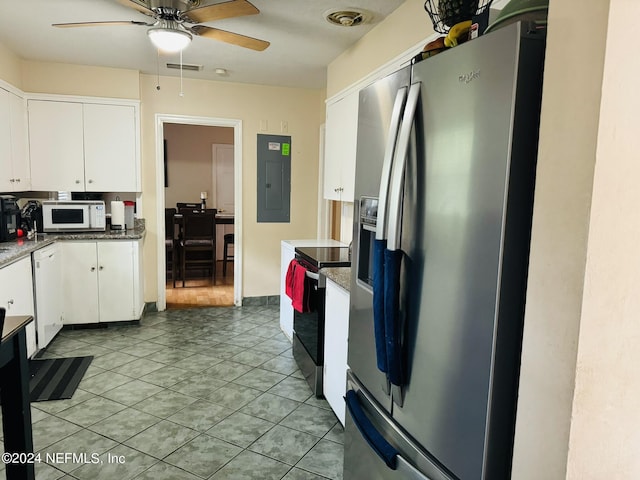 kitchen with appliances with stainless steel finishes, ceiling fan, light tile patterned floors, white cabinets, and electric panel