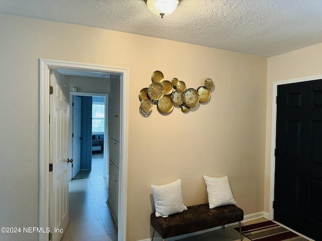 interior space featuring tile patterned flooring and a textured ceiling