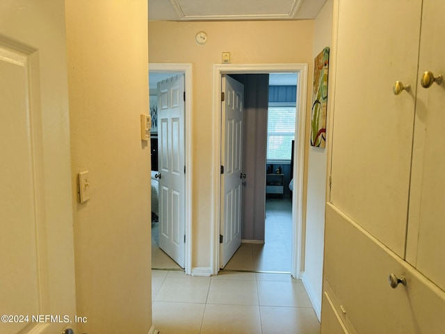 hall featuring light tile patterned flooring