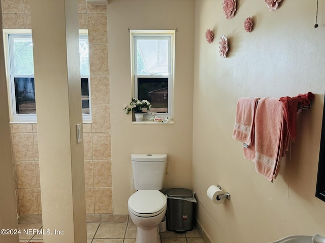 bathroom featuring tile patterned flooring, plenty of natural light, and toilet