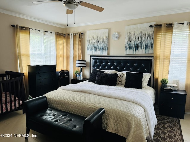 bedroom with multiple windows, ceiling fan, light tile patterned floors, and ornamental molding