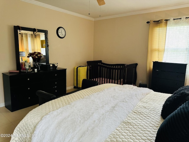 bedroom with ceiling fan, light tile patterned flooring, and crown molding