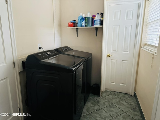 laundry area featuring washing machine and clothes dryer and light tile patterned flooring