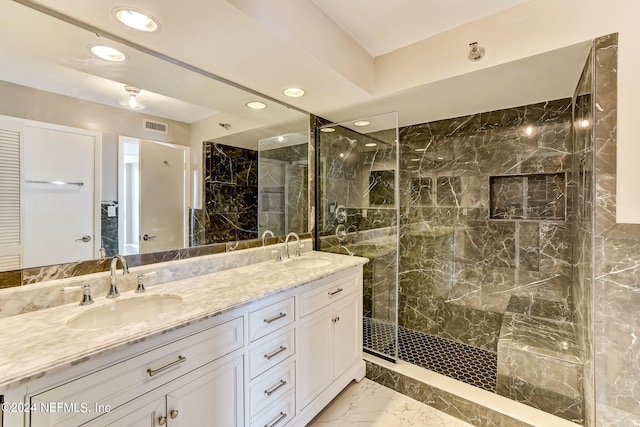 bathroom featuring a tile shower and vanity