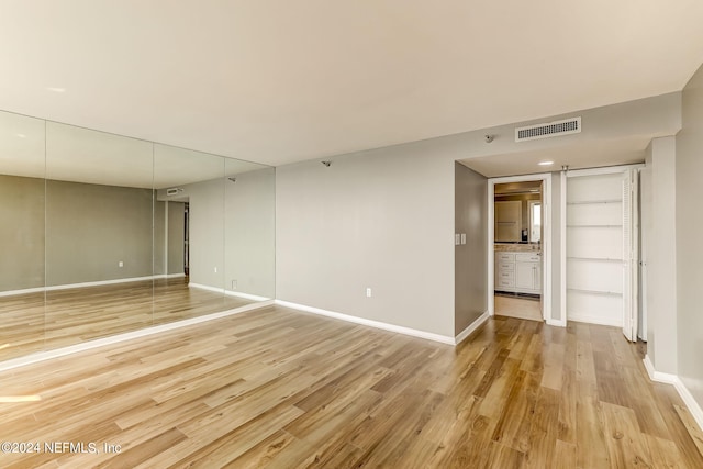 spare room featuring light wood-type flooring