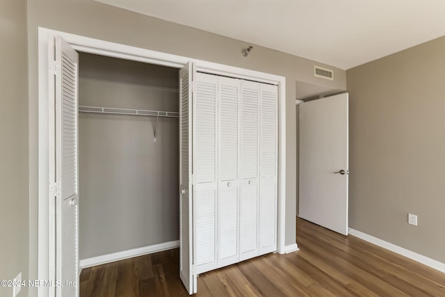 unfurnished bedroom with dark hardwood / wood-style floors