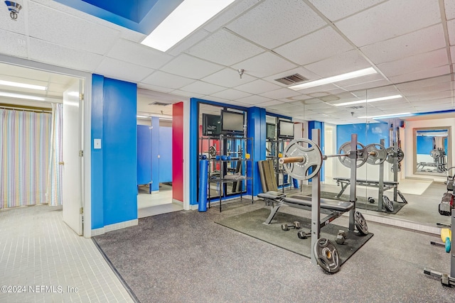 workout area featuring a drop ceiling