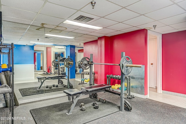 exercise room featuring a paneled ceiling