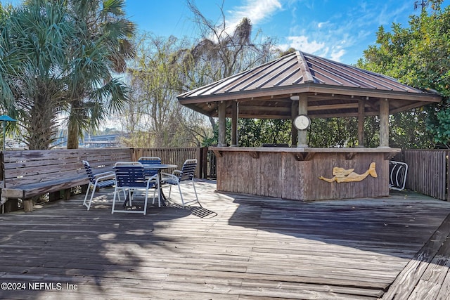 wooden terrace featuring a gazebo