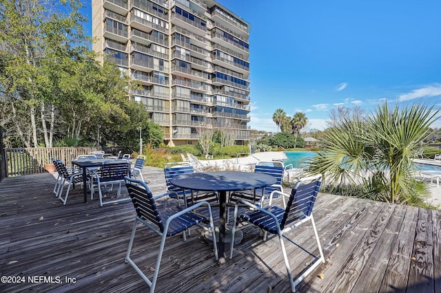 wooden deck with a community pool