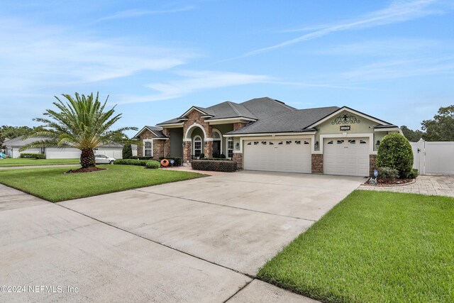 view of front of property featuring a garage and a front lawn