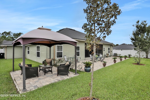 rear view of house featuring a lawn, a patio area, and a gazebo