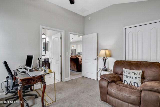 office area with ceiling fan, light carpet, and vaulted ceiling