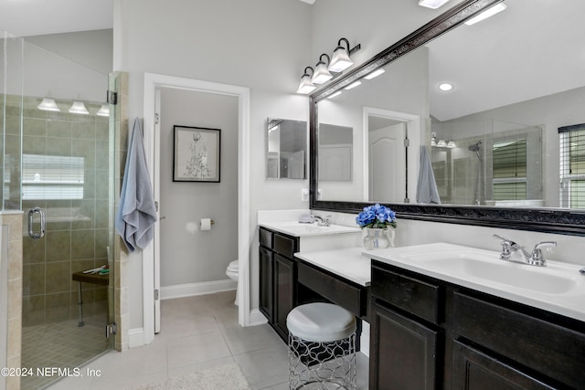 bathroom featuring vanity, toilet, tile patterned floors, and walk in shower