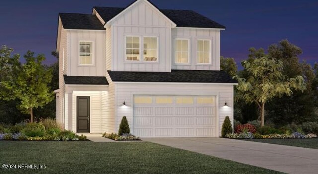 view of front of home with a garage and a front yard