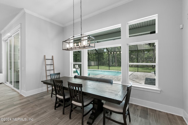 dining area featuring a chandelier and crown molding